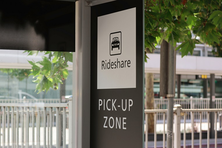 Black and white rideshare pick up zone sign