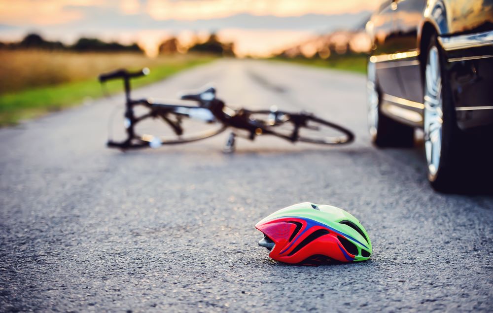 A bicycle and helmet on the road after an accident with a motor vehicle.