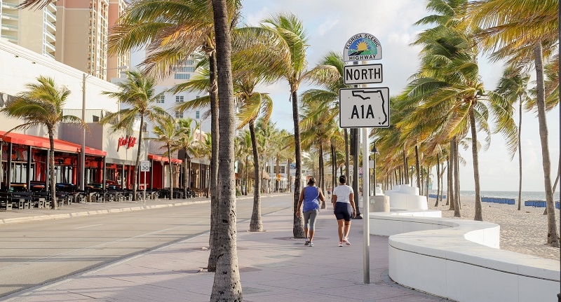 two people walking on north a1a sign in ft lauderdale beach flor