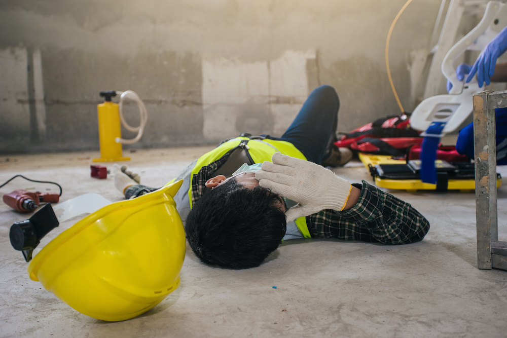 Employee builder accident in construction site work. Builder worker injured and wait for help. First aid worker accident.
