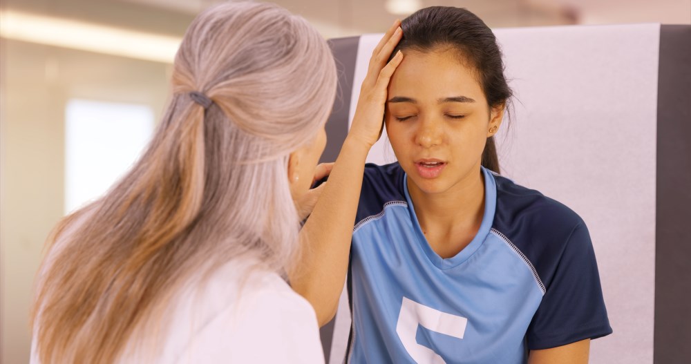 A pediatrician examining a patient after a sports injury.