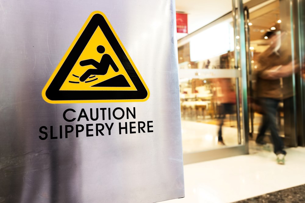 A slip and fall caution sign outside of a Florida store.