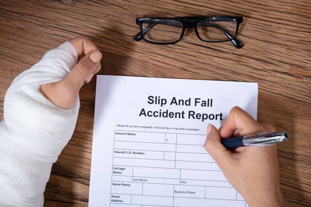 A woman filling out a slip and fall report after experiencing an accident at someone else's property.